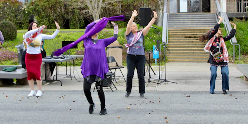 Four women perform a dance
