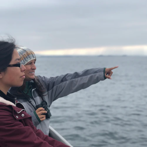 Students pointing at the ocean from a boat