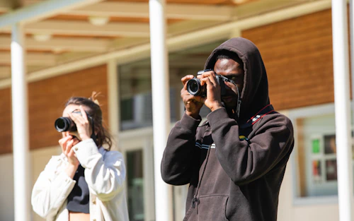 a male and female student taking pictures