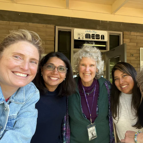 Four women STEM faculty members at Cabrillo College pose in front of a building