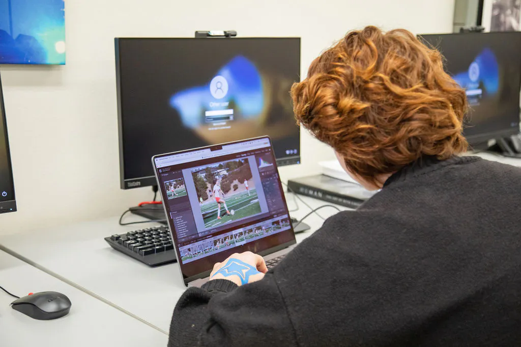 Student working on laptop at workstation 