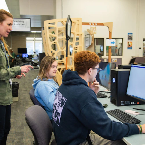 students and an instructor working with the computer