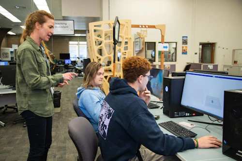 students and an instructor working with the computer