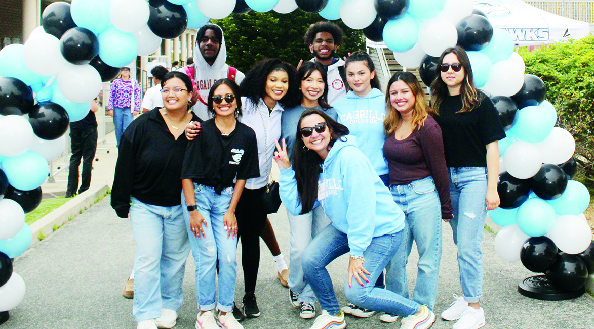 a group of students at Seahawks Take Flight event under a balloon arch