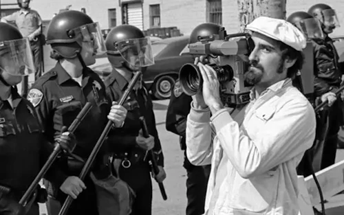 a photo of Jon Silver filming police during the Watsonville Cannery Strike