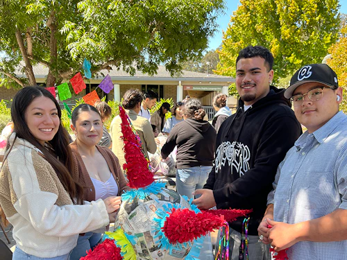 a group of students making a pinata at a 2024 HSI Week event