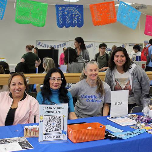 Cabrillo staff behind a table at the Registration Fair