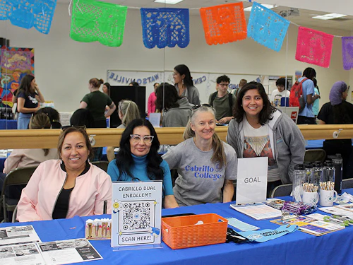 Cabrillo staff behind a table at the Registration Fair