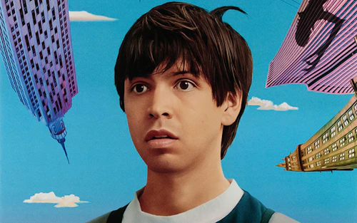 a young man surrounded by tall buildings