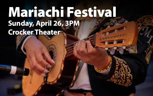 a mariachi musician playing a guitar