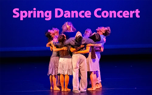 a group of dancers embrace in a circle on stage
